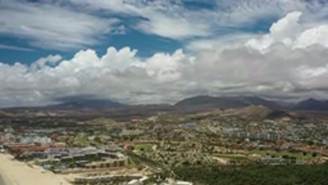 LOS CABOS MEXICO-2020: A City Stretches Across A Mountain Valley Under A Blue
