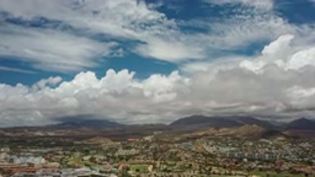LOS CABOS MEXICO-2020: Flying Above Buildings Toward White Clouds and Mountains