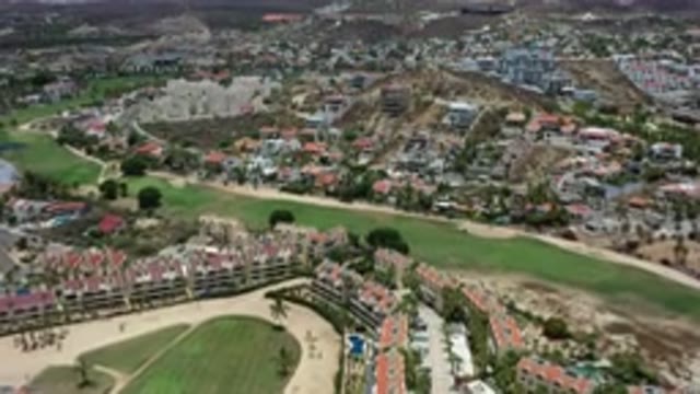LOS CABOS MEXICO-2020: Gliding Overhead a Lush Green City Under Cloudy Skies
