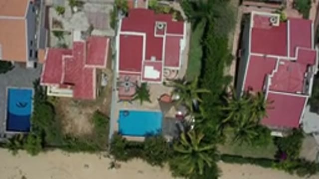LOS CABOS MEXICO-2020: Camera Pans Closer Towards Three Coral Colored Homes
