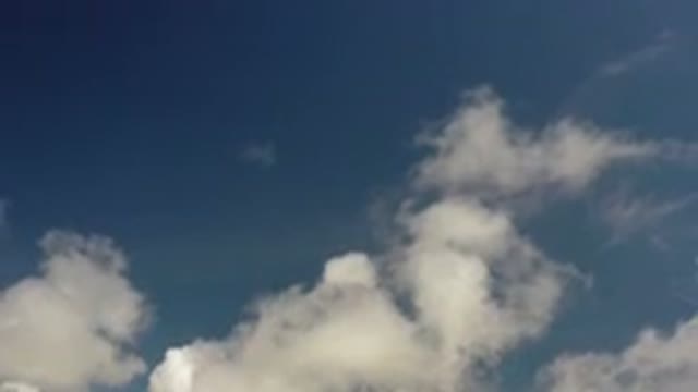 LOS CABOS MEXICO-2020: Fluffy White Clouds Drifting Across a Blue Sky