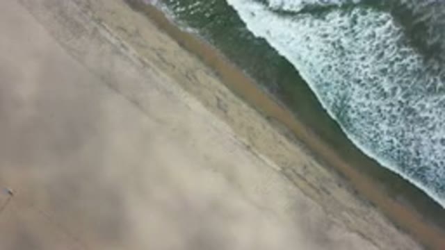 LOS CABOS MEXICO-2020: Tide Crashing Onto The Sandy Seashore On A Windy Day