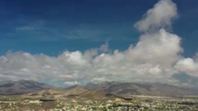 LOS CABOS MEXICO-2020: Mountains Sky Clouds Trees High Above Blue Sky Ground Low