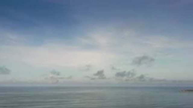 LOS CABOS MEXICO-2020: Camera Pans Up Over A Sliver Of Water And The Sky