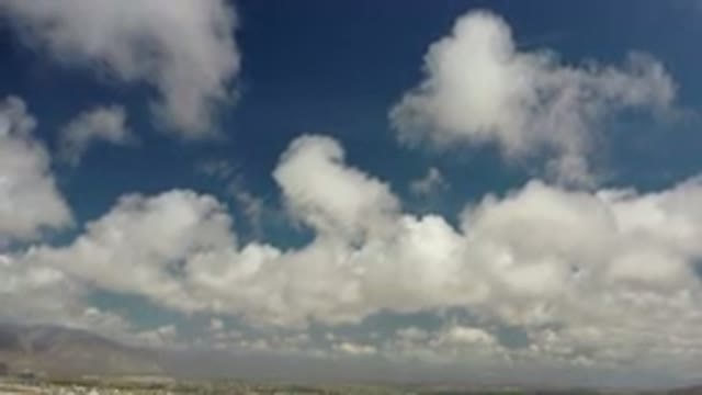 LOS CABOS MEXICO-2020: Clouds Moving Along A Blue Sky With Mountain Peaks
