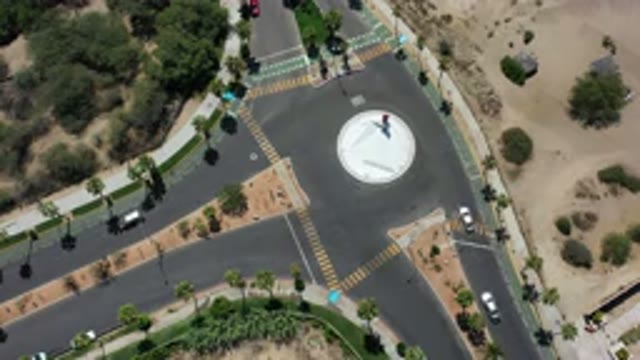 LOS CABOS MEXICO-2020: Overhead View Of Several Cars Moving Slowly Around A Roundabout