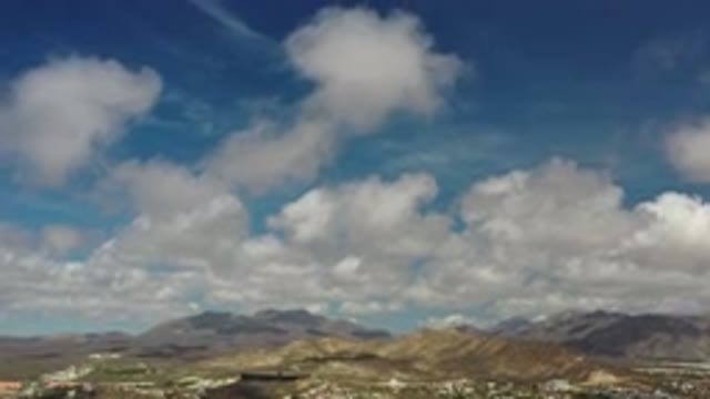 LOS CABOS MEXICO-2020: Blue Sky Filled With Clouds Above Large Mountains In The