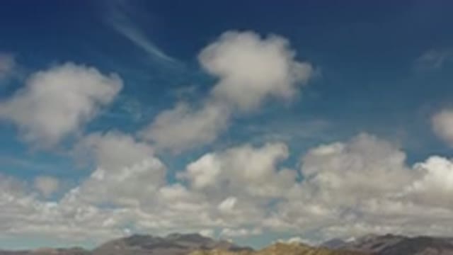 LOS CABOS MEXICO-2020: Puffy White Clouds Above Mountains In A Bright Blue Sky