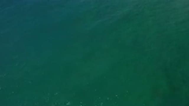 LOS CABOS MEXICO-2020: Aquamarine Water Rolling With Small Waves Reflecting Sunlight