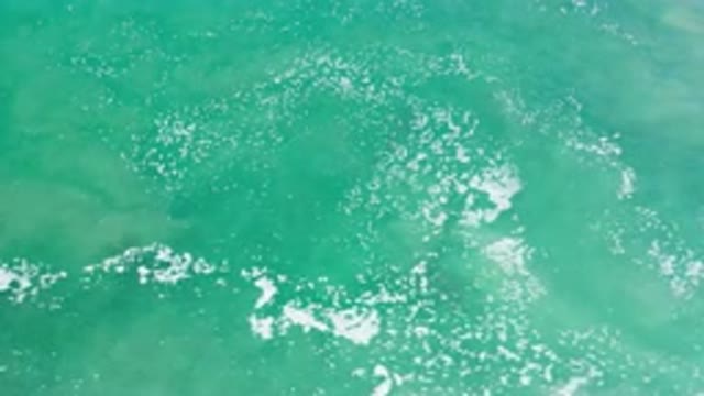 LOS CABOS MEXICO-2020: Sky View Of The Clean And Clear Ocean Waves With Fluffy Clouds