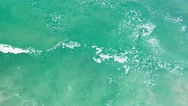 LOS CABOS MEXICO-2020: White Foam And Sand Backwash From Shore As Waves Flow In
