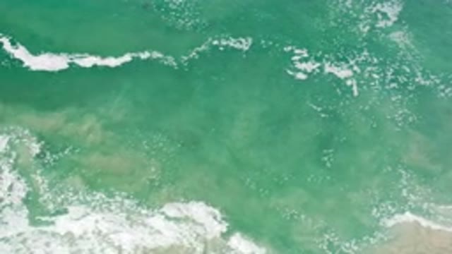 LOS CABOS MEXICO-2020: Crashing Waves Rolling To Shore With School Of Fish