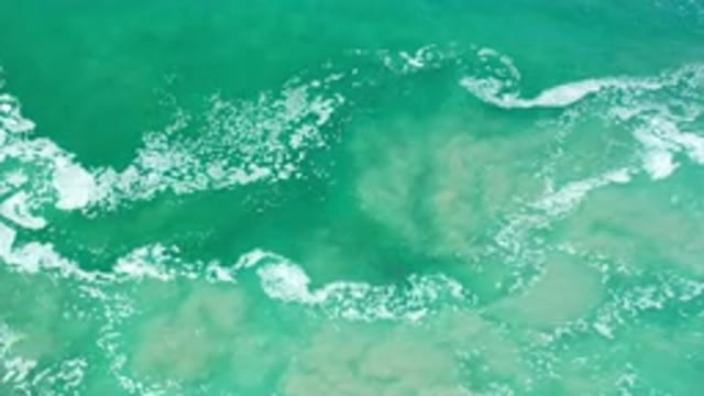 LOS CABOS MEXICO-2020: Cloudy Aqua Green Murky Swirling Waves White Frothy Foam