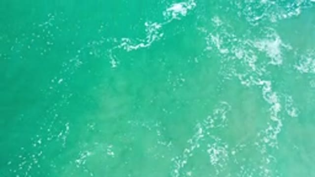 LOS CABOS MEXICO-2020: Clear Water With Small Crashing Waves And Reflection Of