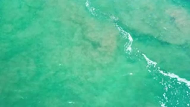 LOS CABOS MEXICO-2020: Calm Green Seas With Visible Bottom Features And Rocks