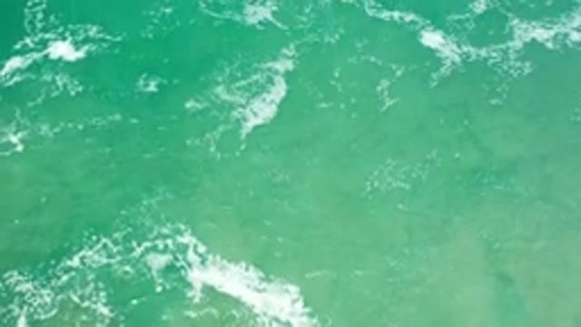 LOS CABOS MEXICO-2020: Sea Green Waves Gently Lapping With White Bubbles And Foam