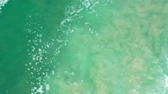 LOS CABOS MEXICO-2020: Blue Green Body Of Water Churning Sand Waves White