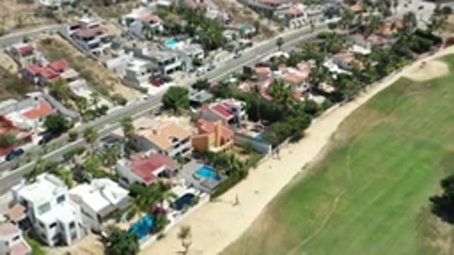 LOS CABOS MEXICO-2020: Aerial View Of Houses On A Street Next To A Park With