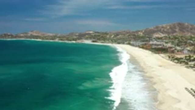 LOS CABOS MEXICO-2020: Beautiful Tide Washes Up On Light Sandy Shore By Rolling Waves