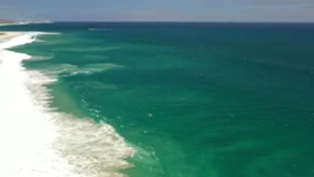 LOS CABOS MEXICO-2020: The Side View Of The Long Blue Beach With Sky