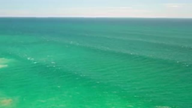 LOS CABOS MEXICO-2020: Green Sea With Calm Tides And Sunset On The Horizon Line