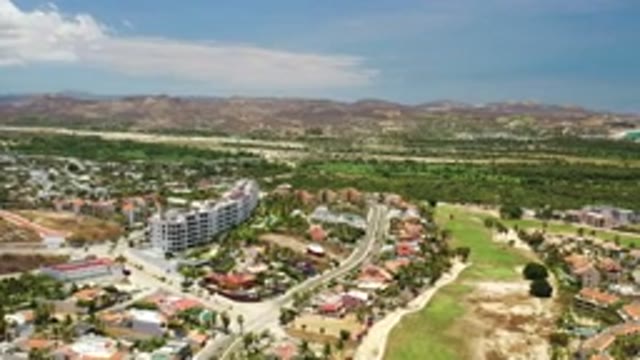 LOS CABOS MEXICO-2020: Flying Above A Community With Mountains And Water In The