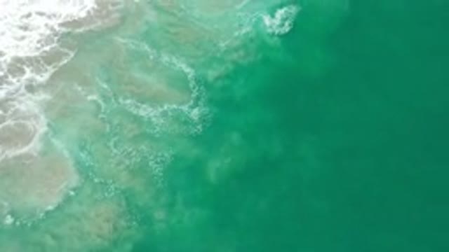 LOS CABOS MEXICO-2020: Green Ocean Waves Turning to White Foam as They Hit Shore