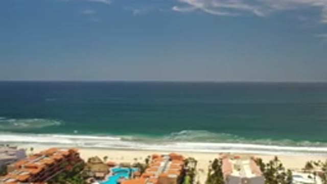 LOS CABOS MEXICO-2020: Bustling Town On The Shore Of An Ocean With Crashing Waves