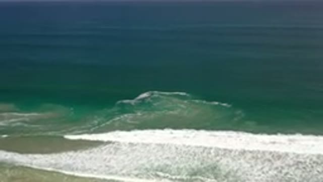 LOS CABOS MEXICO-2020: An Aerial View Of Ocean Surf Pounding Against A Sand