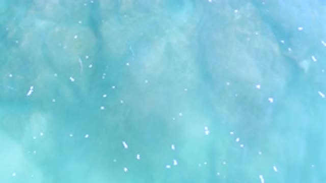 LOS CABOS MEXICO-2020: Blue Shallow Water With The Bottom Showing Has Patches Of White Foam