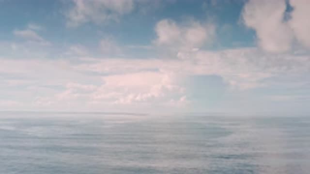 LOS CABOS MEXICO-2020: Soaring in Clouds Midday Over Peaceful Breezy Calm Ocean