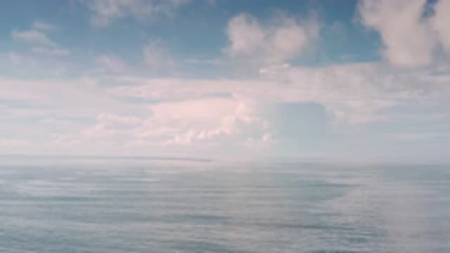 LOS CABOS MEXICO-2020: Drone Shot Of The Ocean Underneath A Cloudy Blue Sky