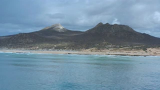 LOS CABOS MEXICO-2020: Footage Of A Sandy Beach Background With Two Mountains On