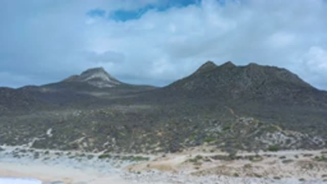 LOS CABOS MEXICO-2020: Twin Mountain Peaks Again From The Beach