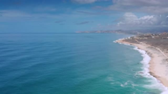 LOS CABOS MEXICO-2020: A Camera Angle Of A Long Stretching Beach Shore Line With