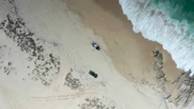 LOS CABOS MEXICO-2020: Beach Scene With Cars Parked Near Bank