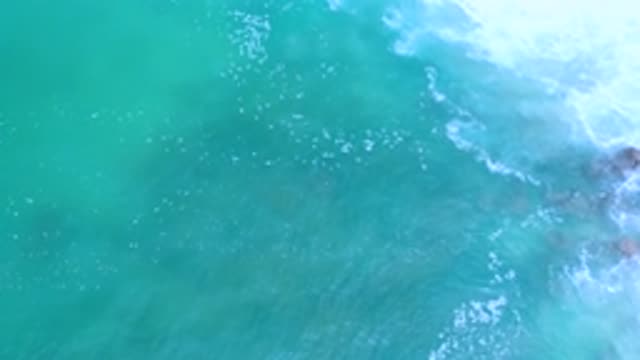 LOS CABOS MEXICO-2020: Churning Blue Green Shallow Water Over Rocks