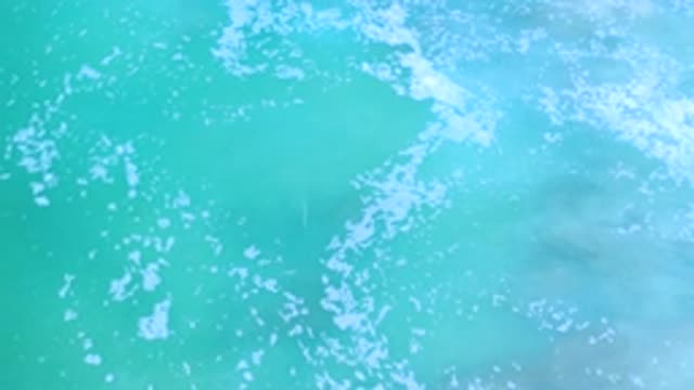 LOS CABOS MEXICO-2020: Slow Rolling Wave In Shallow Ocean Water With Sea Foam