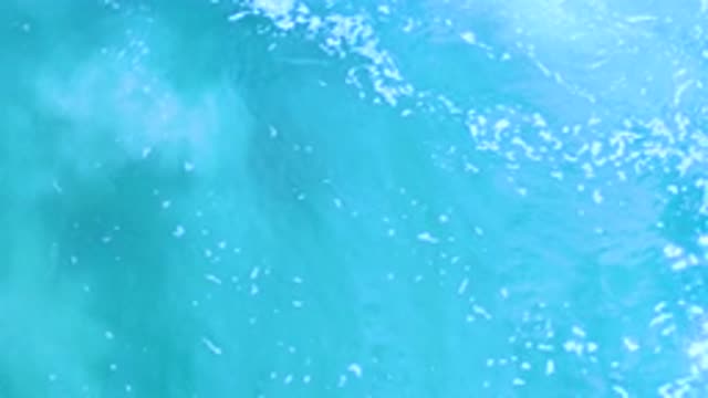 LOS CABOS MEXICO-2020: Turquoise Blue Ocean Water With Small Bubbles Ripples And Light Rays