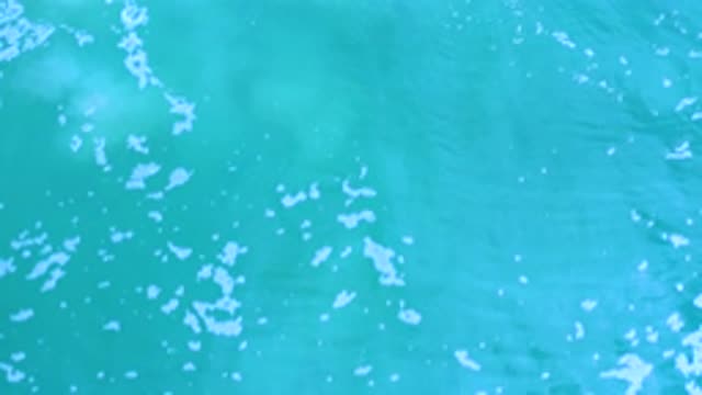 LOS CABOS MEXICO-2020: Blue Slow Wavy Moving Water With White Bubbles With