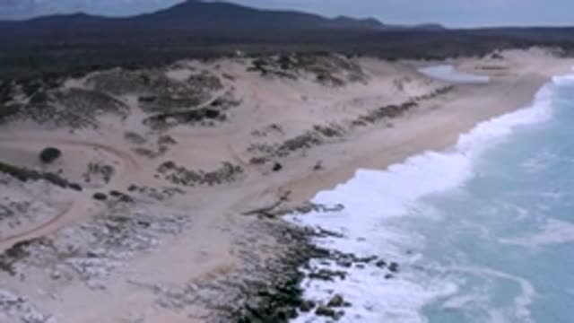 LOS CABOS MEXICO-2020: Drone Shot Of The Ocean Waves Crashing Against The White Sand