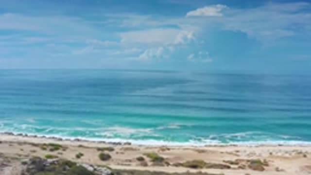 LOS CABOS MEXICO-2020: Towering Clouds Cover The Horizon Of The Ocean As Waves