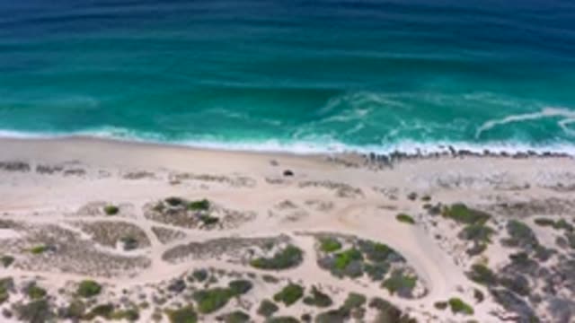 LOS CABOS MEXICO-2020: Beautiful Sandy Shore Line With Waves Moving Back And