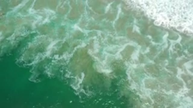LOS CABOS MEXICO-2020: Calm Beach Waves With Semi-translucent Emerald in Color