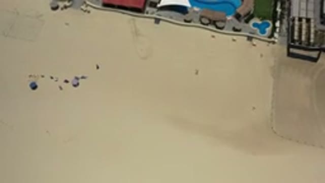 LOS CABOS MEXICO-2020: An Overhead View Of People Walking Across A Sandy Area