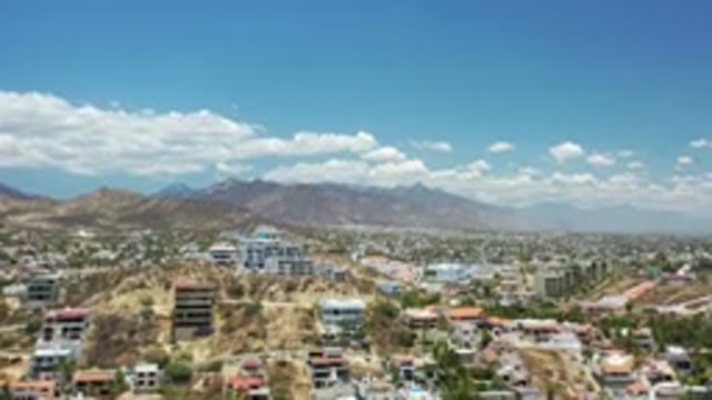 LOS CABOS MEXICO-2020: A Few Houses In The Desert With Shrubs And Mountains In