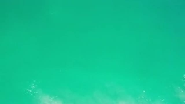 LOS CABOS MEXICO-2020: Teal Water With Ocean Foam Laying On Top Of It