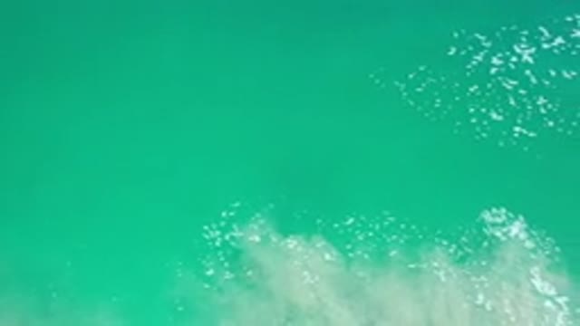 LOS CABOS MEXICO-2020: Brief Passing Green Ocean Water Footage With Two White Foam Masses