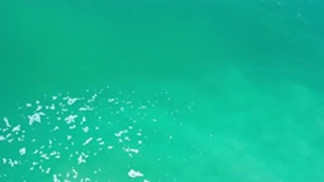 LOS CABOS MEXICO-2020: Calm Blue Green Ocean Water With White Sea Foam Bubbles