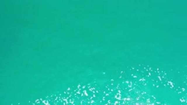 LOS CABOS MEXICO-2020: White Sea Foam Bubbling On A Blue Green Body Of Water